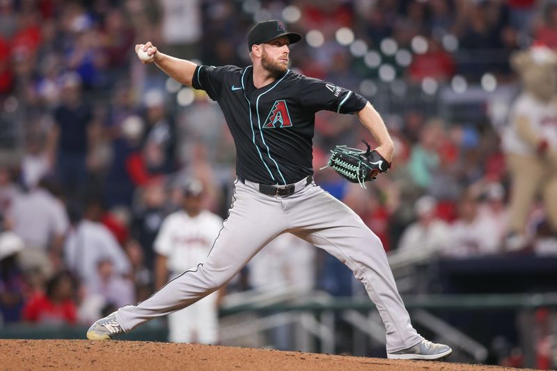 Jun 4, 2025; Atlanta, Georgia, USA; Arizona Diamondbacks starting pitcher Merrill Kelly (29) throws against the Atlanta Braves in the seventh inning at Truist Park. Mandatory Credit: Brett Davis-Imagn Images
