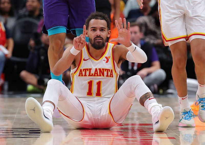 ATLANTA, GEORGIA - OCTOBER 25:  Trae Young #11 of the Atlanta Hawks reacts after LaMelo Ball #1 of the Charlotte Hornets fouled out during the fourth quarter at State Farm Arena on October 25, 2024 in Atlanta, Georgia.  NOTE TO USER: User expressly acknowledges and agrees that, by downloading and/or using this photograph, user is consenting to the terms and conditions of the Getty Images License Agreement.  (Photo by Kevin C. Cox/Getty Images)