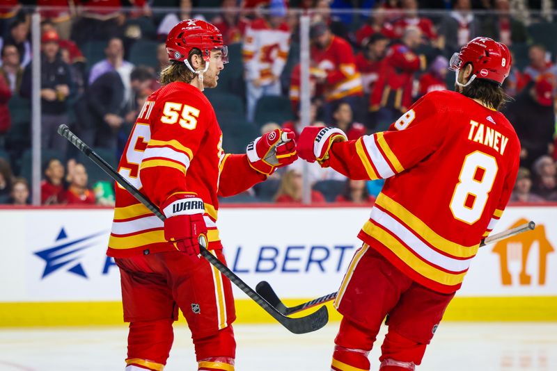 Jan 9, 2024; Calgary, Alberta, CAN; Calgary Flames defenseman Noah Hanifin (55) celebrates his goal with Calgary Flames defenseman Chris Tanev (8) during the third period against the Ottawa Senators at Scotiabank Saddledome. Mandatory Credit: Sergei Belski-USA TODAY Sports