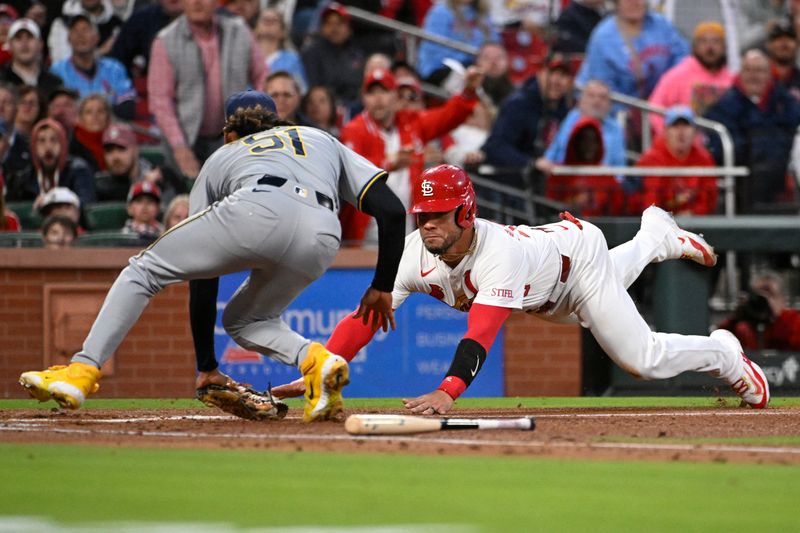 Apr 19, 2024; St. Louis, Missouri, USA; St. Louis Cardinals catcher Willson Contreras (40) slides into home plate and is tagged out by Milwaukee Brewers pitcher Freddy Peralta (51) in the second inning at Busch Stadium. Mandatory Credit: Joe Puetz-USA TODAY Sports