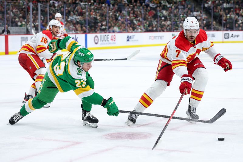Nov 9, 2025; Saint Paul, Minnesota, USA; Calgary Flames defenseman Kevin Bahl (7) and Minnesota Wild center Marco Rossi (23) compete for the puck during the third period at Grand Casino Arena. Mandatory Credit: Matt Krohn-Imagn Images