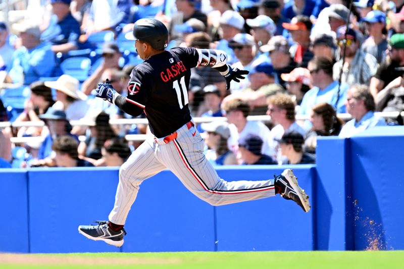 Mar 11, 2025; Dunedin, Florida, USA; Minnesota Twins designated hitter Mickey Gasper (11) prepares to round first base on the way to a double in the second  inning against the Toronto Blue Jays during spring training  at TD Ballpark. Mandatory Credit: Jonathan Dyer-Imagn Images