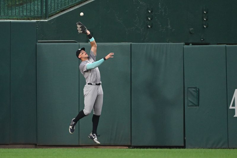 Aug 26, 2024; Washington, District of Columbia, USA; New York Yankees center fielder Aaron Judge (99) leaps to make a catch agains the wall against the Washington Nationals during the second inning at Nationals Park. Mandatory Credit: Rafael Suanes-USA TODAY Sports