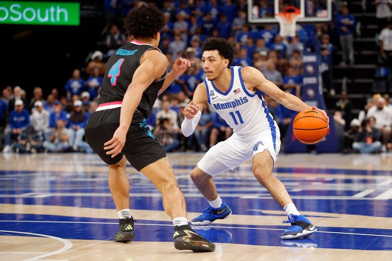 Feb 25, 2024; Memphis, Tennessee, USA; Memphis Tigers guard Jahvon Quinerly (11) dribbles as Florida Atlantic Owls guard Bryan Greenlee (4) defends during the first half at FedExForum. Mandatory Credit: Petre Thomas-USA TODAY Sports