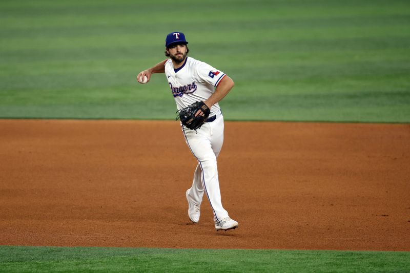 Jun 22, 2024; Arlington, Texas, USA; Texas Rangers third base Josh Smith (8) throws the ball to first base in the fifth inning against the Kansas City Royals at Globe Life Field. Mandatory Credit: Tim Heitman-USA TODAY Sports