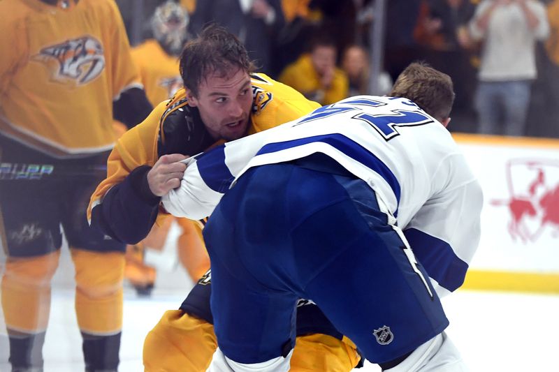 Dec 7, 2023; Nashville, Tennessee, USA; Nashville Predators left wing Cole Smith (36) and Tampa Bay Lightning left wing Austin Watson (51) fight during the third period at Bridgestone Arena. Mandatory Credit: Christopher Hanewinckel-USA TODAY Sports