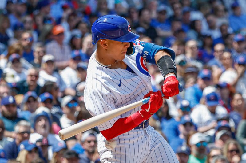 May 5, 2023; Chicago, Illinois, USA; Chicago Cubs catcher Miguel Amaya (6) is hit by a pitch from Miami Marlins starting pitcher Edward Cabrera (not pictured) during the first inning at Wrigley Field. Mandatory Credit: Kamil Krzaczynski-USA TODAY Sports