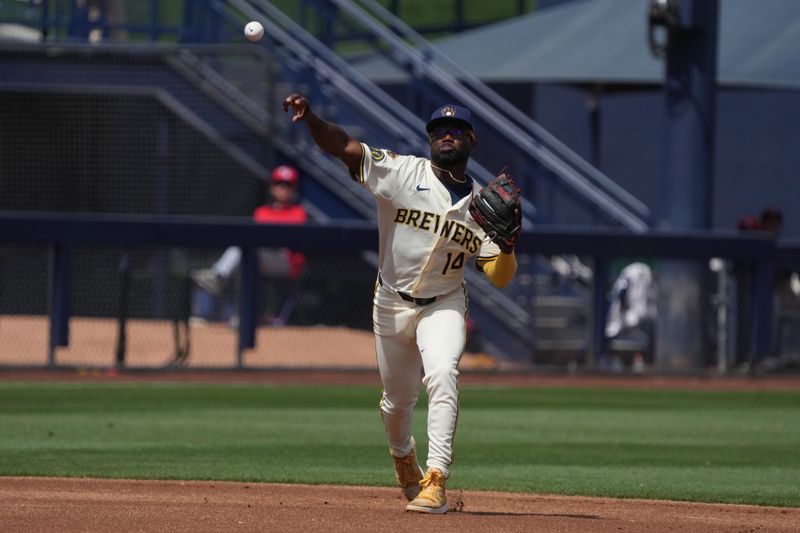 Mar 16, 2025; Phoenix, Arizona, USA; Milwaukee Brewers third base Andruw Monasterio (14) makes the play against the Cleveland Guardians in the first inning at American Family Fields of Phoenix. Mandatory Credit: Rick Scuteri-Imagn Images