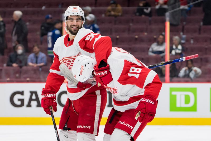 Feb 13, 2023; Vancouver, British Columbia, CAN; Detroit Red Wings forward Joe Veleno (90) and forward Andrew Copp (18) celebrate the victory over the Vancouver Canucks at Rogers Arena. Red Wings won 6-1. Mandatory Credit: Bob Frid-USA TODAY Sports