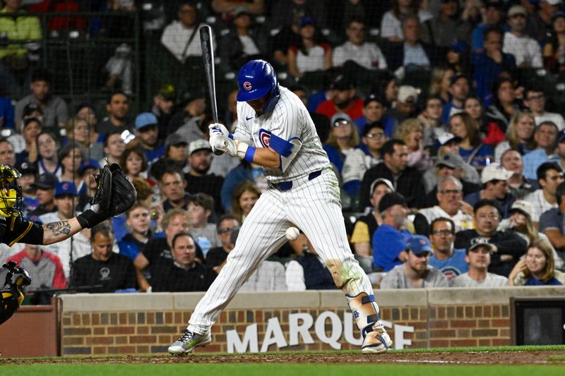 May 16, 2024; Chicago, Illinois, USA;  Chicago Cubs outfielder Seiya Suzuki (27) is hit by a pitch thrown by Pittsburgh Pirates pitcher Colin Holderman (35) during the eighth inning at Wrigley Field. Mandatory Credit: Matt Marton-USA TODAY Sports