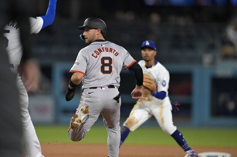 Apr 2, 2024; Los Angeles, California, USA;  San Francisco Giants Michael Conforto (8) is caught in a run down play in the third inning against the Los Angeles Dodgers at Dodger Stadium. Mandatory Credit: Jayne Kamin-Oncea-USA TODAY Sports