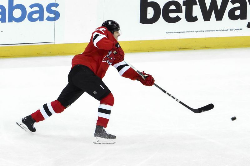 Feb 8, 2024; Newark, New Jersey, USA; New Jersey Devils defenseman Santeri Hatakka (82) takes a shot against the Calgary Flames during the third period at Prudential Center. Mandatory Credit: John Jones-USA TODAY Sports