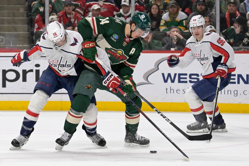 Jan 23, 2024; Saint Paul, Minnesota, USA;  Washington Capitals forward Nic Dowd (26) and Minnesota Wild forward Joel Eriksson Ek (14) battle for a puck as forward Nicolas Aube-Kubel (96) looks on during the third period at Xcel Energy Center. Mandatory Credit: Nick Wosika-USA TODAY Sports