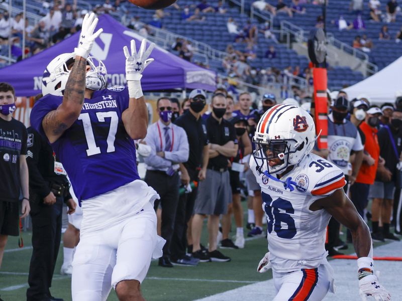 Jan 1, 2021; Orlando, FL, USA; Auburn Tigers defensive back Jaylin Simpson (36) covers a pass intended for Northwestern Wildcats wide receiver Bryce Kirtz (17) during the second half at Camping World Stadium. Mandatory Credit: Reinhold Matay-USA TODAY Sports