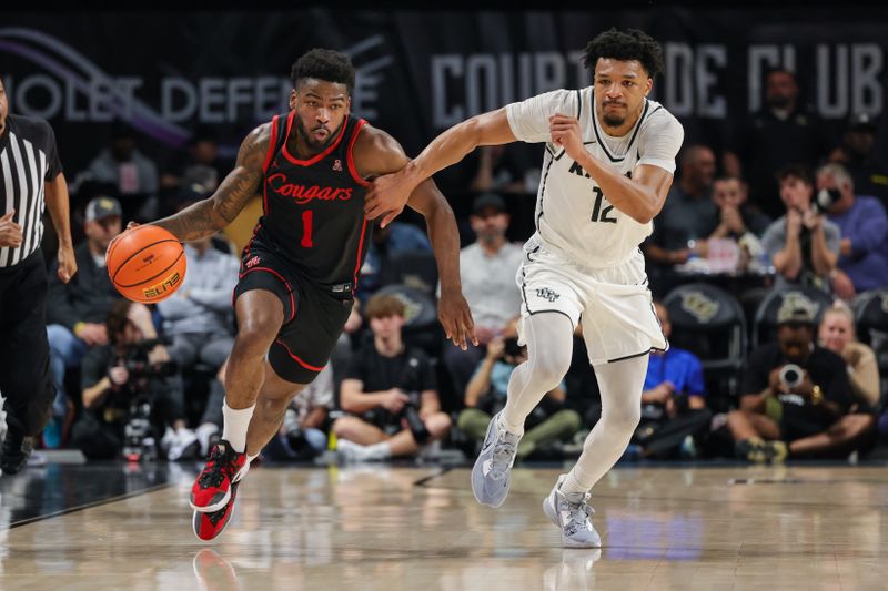 Jan 25, 2023; Orlando, Florida, USA; Houston Cougars guard Jamal Shead (1) brings the ball up court against UCF Knights guard Ithiel Horton (12) during the second half at Addition Financial Arena. Mandatory Credit: Mike Watters-USA TODAY Sports