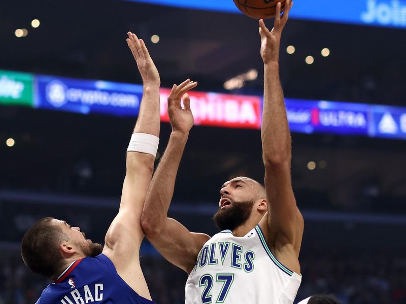 LOS ANGELES, CALIFORNIA - FEBRUARY 12: Rudy Gobert #27 of the Minnesota Timberwolves shoots the ball against Ivica Zubac #40 and Terance Mann #14 of the Los Angeles Clippers during the first quarter at Crypto.com Arena on February 12, 2024 in Los Angeles, California. NOTE TO USER: User expressly acknowledges and agrees that, by downloading and or using this photograph, user is consenting to the terms and conditions of the Getty Images License Agreement. (Photo by Katelyn Mulcahy/Getty Images)