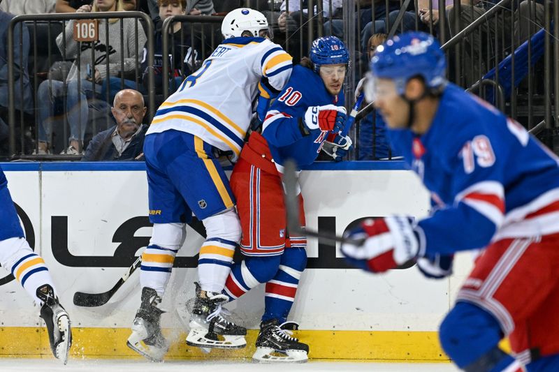 Nov 7, 2024; New York, New York, USA;  Buffalo Sabres defenseman Dennis Gilbert (8) checks New York Rangers left wing Artemi Panarin (10) during the first period at Madison Square Garden. Mandatory Credit: Dennis Schneidler-Imagn Images