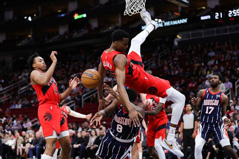 HOUSTON, TEXAS - FEBRUARY 03: Christian Koloko #35 of the Toronto Raptors collides with Jae'Sean Tate #8 of the Houston Rockets during the first half at Toyota Center on February 03, 2023 in Houston, Texas. NOTE TO USER: User expressly acknowledges and agrees that, by downloading and or using this photograph, User is consenting to the terms and conditions of the Getty Images License Agreement. (Photo by Carmen Mandato/Getty Images)