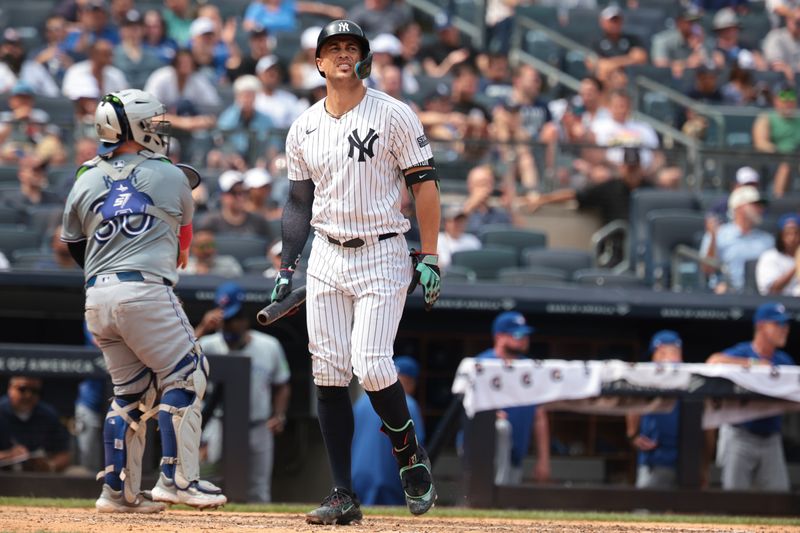 Aug 4, 2024; Bronx, New York, USA; New York Yankees designated hitter Giancarlo Stanton (27) reacts after striking out with the bases loaded during the fifth inning against the Toronto Blue Jays at Yankee Stadium. Mandatory Credit: Vincent Carchietta-USA TODAY Sports