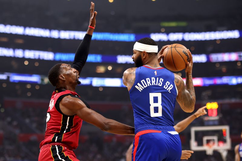 LOS ANGELES, CALIFORNIA - JANUARY 02: Bam Adebayo #13 of the Miami Heat defends against Marcus Morris Sr. #8 of the Los Angeles Clippers during the first quarter at Crypto.com Arena on January 02, 2023 in Los Angeles, California. NOTE TO USER: User expressly acknowledges and agrees that, by downloading and or using this photograph, User is consenting to the terms and conditions of the Getty Images License Agreement. (Photo by Katelyn Mulcahy/Getty Images)