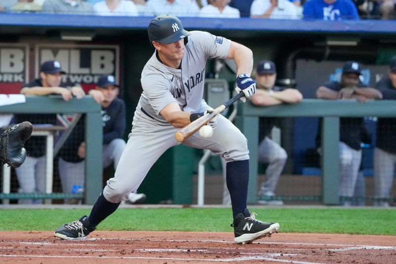 Jun 10, 2024; Kansas City, Missouri, USA; New York Yankees first baseman DJ LeMahieu (26) hits an RBI sacrifice bunt against the Kansas City Royals in the first inning at Kauffman Stadium. Mandatory Credit: Denny Medley-USA TODAY Sports