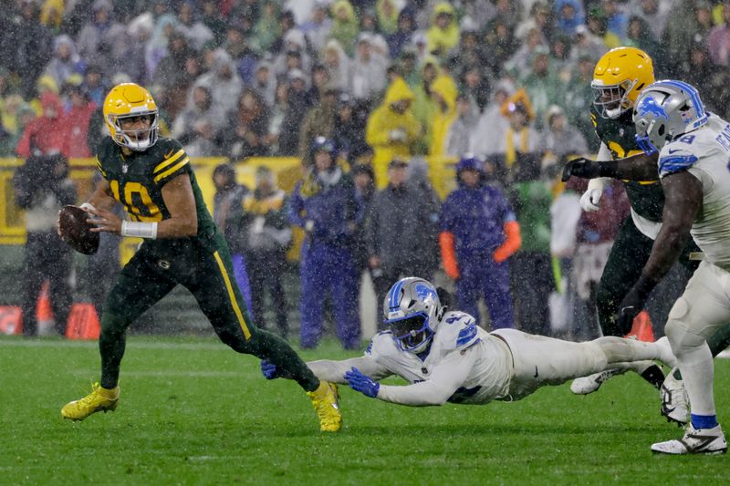 Green Bay Packers quarterback Jordan Love (10) is pressured by Detroit Lions linebacker James Houston (41) during the second half of an NFL football game Sunday, Nov. 3, 2024, in Green Bay, Wis. (AP Photo/Matt Ludtke)