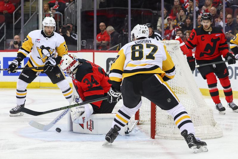 Mar 19, 2024; Newark, New Jersey, USA; New Jersey Devils goaltender Jake Allen (34) makes a save against the Pittsburgh Penguins during the first period at Prudential Center. Mandatory Credit: Ed Mulholland-USA TODAY Sports