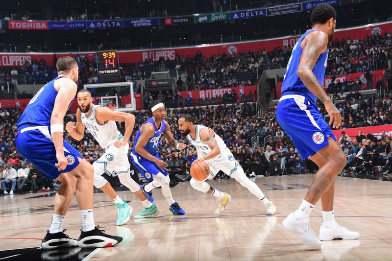 LOS ANGELES, CA - FEBRUARY 12:  Mike Conley #10 of the Minnesota Timberwolves handles the ball during the game  on February 12, 2024 at Crypto.Com Arena in Los Angeles, California. NOTE TO USER: User expressly acknowledges and agrees that, by downloading and/or using this Photograph, user is consenting to the terms and conditions of the Getty Images License Agreement. Mandatory Copyright Notice: Copyright 2024 NBAE (Photo by Adam Pantozzi/NBAE via Getty Images)