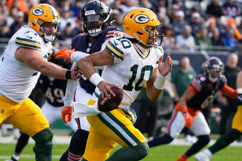 Green Bay Packers' Jordan Love scrambles during the first half of an NFL football game against the Chicago Bears Sunday, Nov. 17, 2024, in Chicago. (AP Photo/Nam Y. Huh)