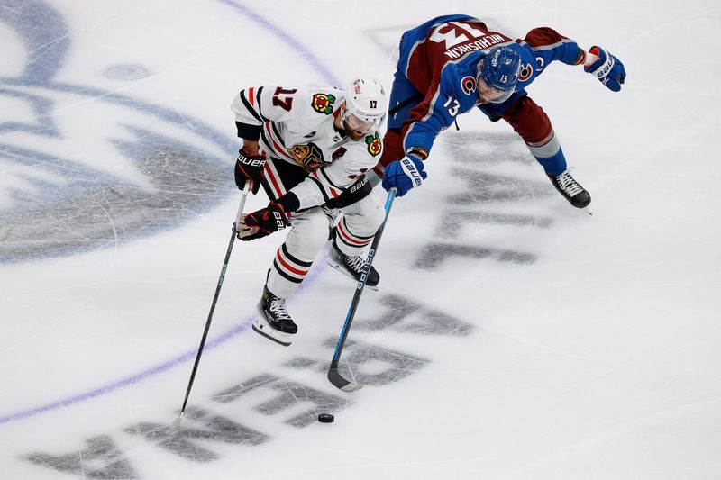 Oct 19, 2023; Denver, Colorado, USA; Chicago Blackhawks left wing Nick Foligno (17) controls the puck under pressure from Colorado Avalanche right wing Valeri Nichushkin (13) in the third period at Ball Arena. Mandatory Credit: Isaiah J. Downing-USA TODAY Sports