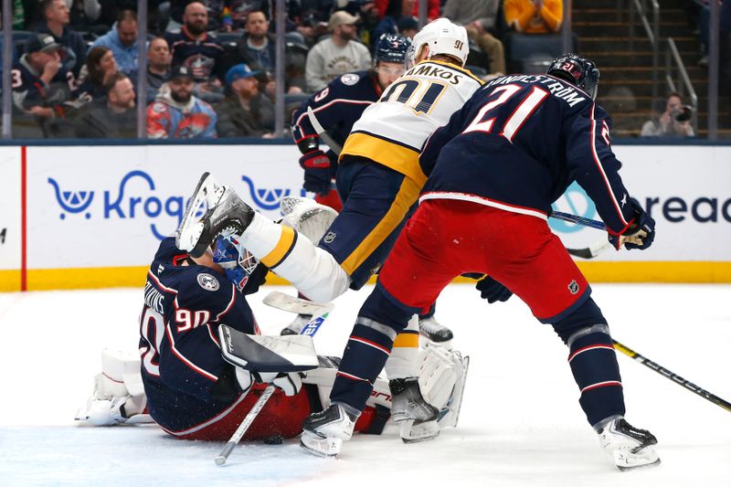 Mar 3, 2026; Columbus, Ohio, USA; Columbus Blue Jackets goalie Elvis Merzlikins (90) falls to the ice as he makes a save as Nashville Predators center Steven Stamkos (91) looks for a rebound during the first period at Nationwide Arena. Mandatory Credit: Russell LaBounty-Imagn Images