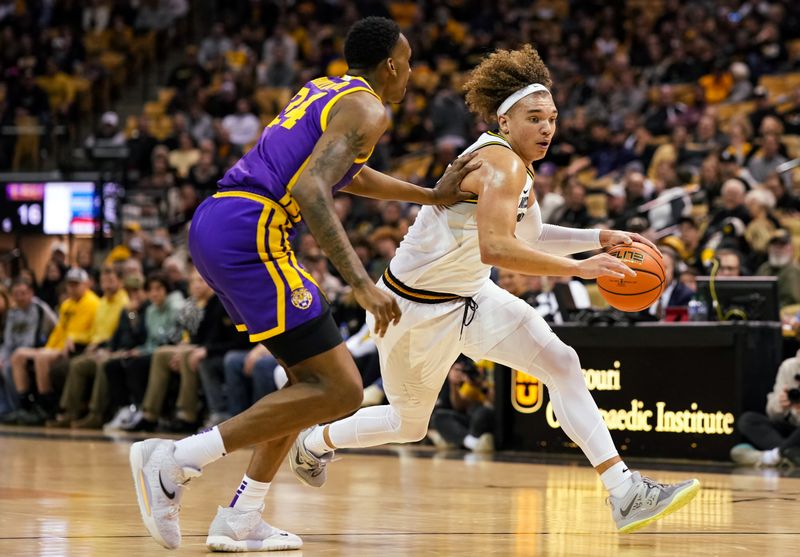 Feb 1, 2023; Columbia, Missouri, USA; Missouri Tigers forward Noah Carter (35) moves against LSU Tigers forward Shawn Phillips (34) during the first half at Mizzou Arena. Mandatory Credit: Jay Biggerstaff-USA TODAY Sports