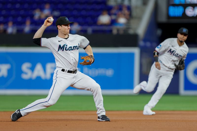 Jun 21, 2023; Miami, Florida, USA; Miami Marlins shortstop Joey Wendle (18) throws the baseball to first baseman Garrett Cooper (not pictured) to retire Toronto Blue Jays second baseman Whit Merrifield (not pictured) during the first inning at loanDepot Park. Mandatory Credit: Sam Navarro-USA TODAY Sports