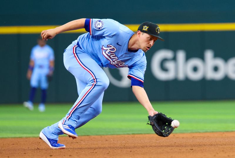 May 19, 2024; Arlington, Texas, USA; Texas Rangers shortstop Corey Seager (5) fields a ground ball during the eighth inning against the Los Angeles Angels at Globe Life Field. Mandatory Credit: Kevin Jairaj-USA TODAY Sports