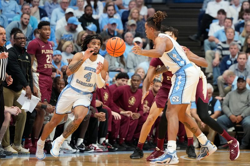 Dec 2, 2023; Chapel Hill, North Carolina, USA;  North Carolina Tar Heels forward Armando Bacot (5) passes the ball to guard RJ Davis (4) in the first half at Dean E. Smith Center. Mandatory Credit: Bob Donnan-USA TODAY Sports