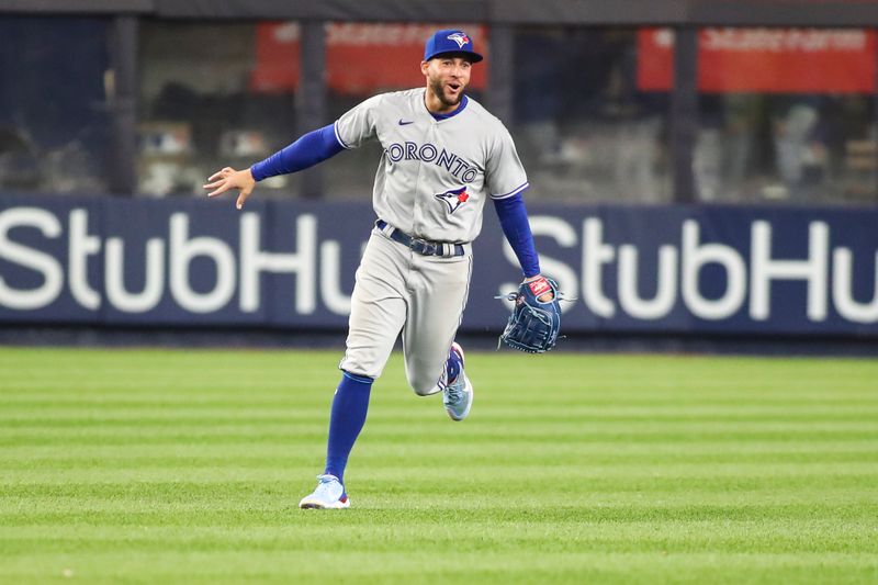 Apr 13, 2022; Bronx, New York, USA;  Toronto Blue Jays center fielder George Springer (4) celebrates after defeating the New York Yankees 6-4 at Yankee Stadium. Mandatory Credit: Wendell Cruz-USA TODAY Sports