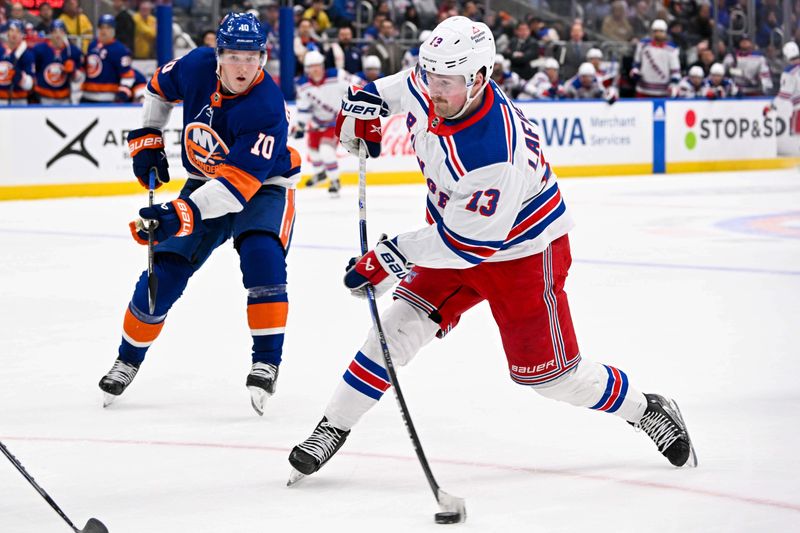 Apr 9, 2024; Elmont, New York, USA; New York Rangers left wing Alexis Lafrenière (13) attempts a shot against the New York Islanders during the third period at UBS Arena. Mandatory Credit: Dennis Schneidler-USA TODAY Sports