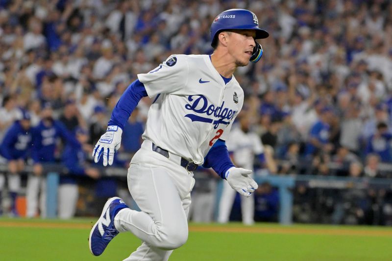 Oct 26, 2024; Los Angeles, California, USA; Los Angeles Dodgers shortstop Tommy Edman (25) runs after hitting a double in the third inning against the New York Yankees during game two of the 2024 MLB World Series at Dodger Stadium. Mandatory Credit: Jayne Kamin-Oncea-Imagn Images