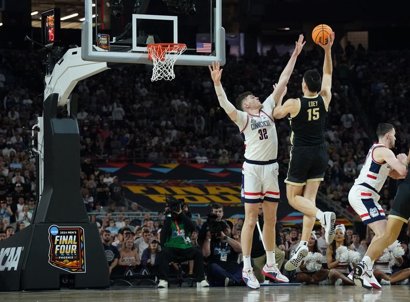 Apr 8, 2024; Glendale, AZ, USA; Purdue Boilermakers center Zach Edey (15) shoots over Connecticut Huskies center Donovan Clingan (32) in the national championship game of the Final Four of the 2024 NCAA Tournament at State Farm Stadium. Mandatory Credit: Robert Deutsch-USA TODAY Sports