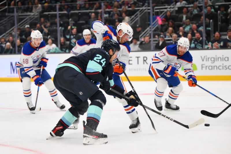 Oct 2, 2024; Seattle, Washington, USA; Edmonton Oilers left wing Drake Caggiula (8) and Seattle Kraken defenseman Jamie Oleksiak (24) play the puck during the third period at Climate Pledge Arena. Mandatory Credit: Steven Bisig-Imagn Images