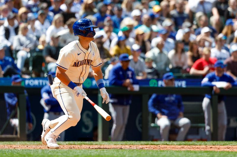 Jun 16, 2024; Seattle, Washington, USA; Seattle Mariners right fielder Dominc Canzone (8) hits an RBI-single against the Texas Rangers during the eighth inning at T-Mobile Park. Mandatory Credit: Joe Nicholson-USA TODAY Sports