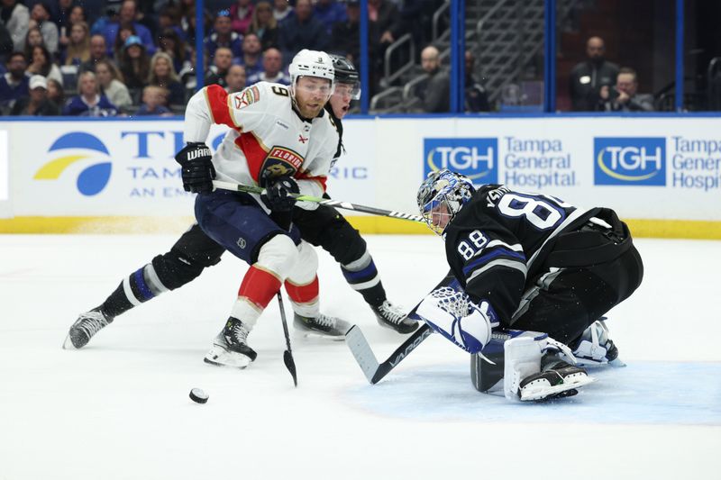 Feb 17, 2024; Tampa, Florida, USA;  Tampa Bay Lightning goaltender Andrei Vasilevskiy (88) saves a shot from Florida Panthers center Sam Bennett (9) in the second period at Amalie Arena. Mandatory Credit: Nathan Ray Seebeck-USA TODAY Sports