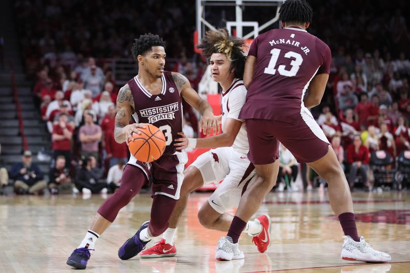 Feb 11, 2023; Fayetteville, Arkansas, USA; Mississippi State Bulldogs guard Shakeel Moore (3) dribbles against Arkansas Razorbacks guard Anthony Black (0) as Bulldogs forward Will McNair Jr (13) sets a screen during the second half at Bud Walton Arena. The Bulldogs won 70-64. Mandatory Credit: Nelson Chenault-USA TODAY Sports