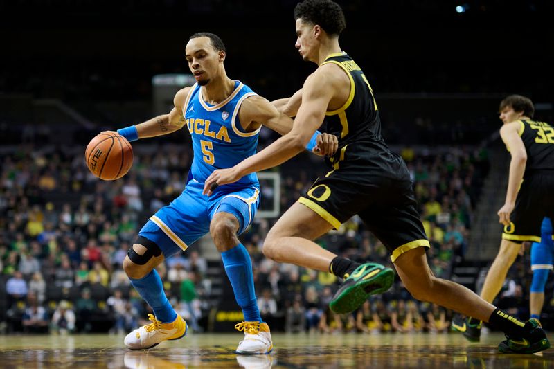 Feb 11, 2023; Eugene, Oregon, USA; UCLA Bruins guard Amari Bailey (5) drives to the basket during the second half against Oregon Ducks guard Will Richardson (0) at Matthew Knight Arena. Mandatory Credit: Troy Wayrynen-USA TODAY Sports