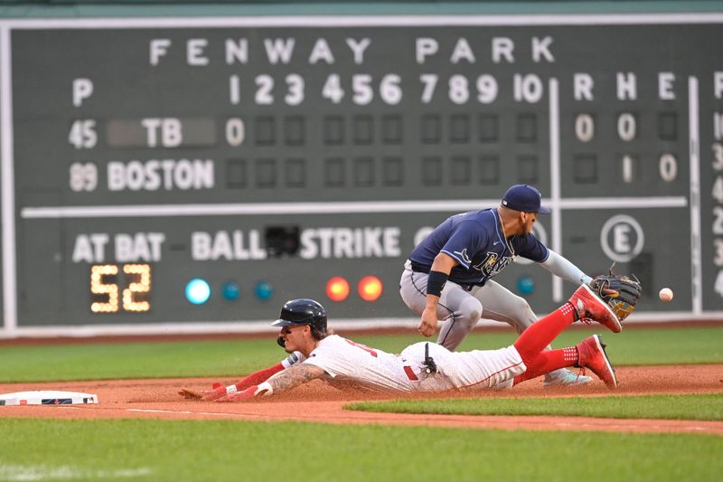 May 15, 2024; Boston, Massachusetts, USA; Boston Red Sox center fielder Jarren Duran (16) slides into second base against Tampa Bay Rays third baseman Isaac Paredes (17) at Fenway Park. Mandatory Credit: Eric Canha-USA TODAY Sports