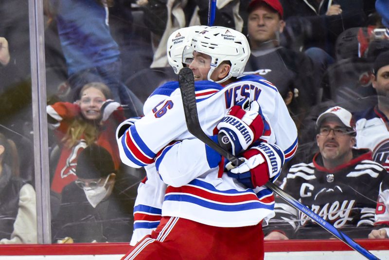 Nov 18, 2023; Newark, New Jersey, USA; New York Rangers left wing Jimmy Vesey (26) celebrates with teammates after scoring a goal against the New Jersey Devils during the third period at Prudential Center. Mandatory Credit: John Jones-USA TODAY Sports