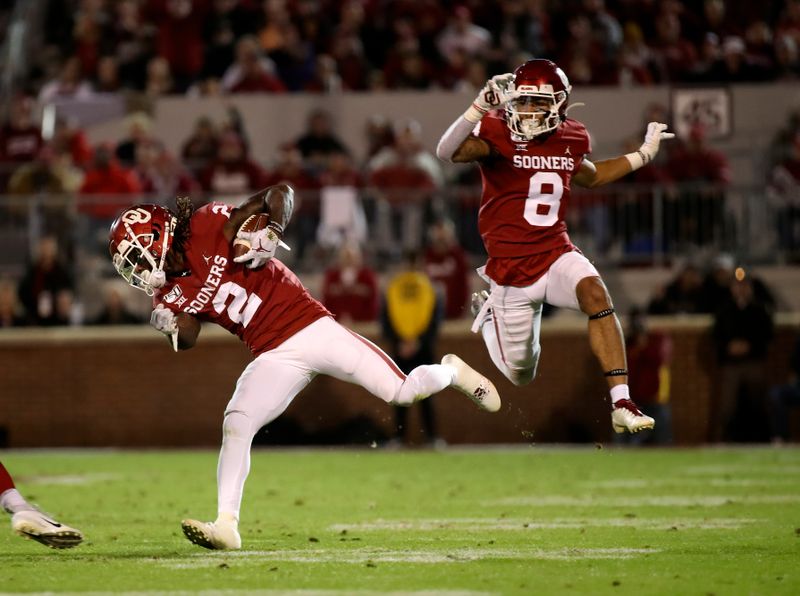 Nov 9, 2019; Norman, OK, USA; Oklahoma Sooners wide receiver CeeDee Lamb (2) runs for a touchdown as  wide receiver Trejan Bridges (8) leaps during the second quarter against the Iowa State Cyclones at Gaylord Family - Oklahoma Memorial Stadium. Mandatory Credit: Kevin Jairaj-USA TODAY Sports