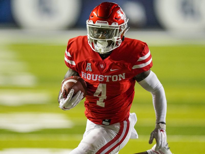 Sep 11, 2021; Houston, Texas, USA;  Houston Cougars running back Ta'Zhawn Henry (4) runs for a score in the second half against the Rice Owls at Rice Stadium. Mandatory Credit: Daniel Dunn-USA TODAY Sports