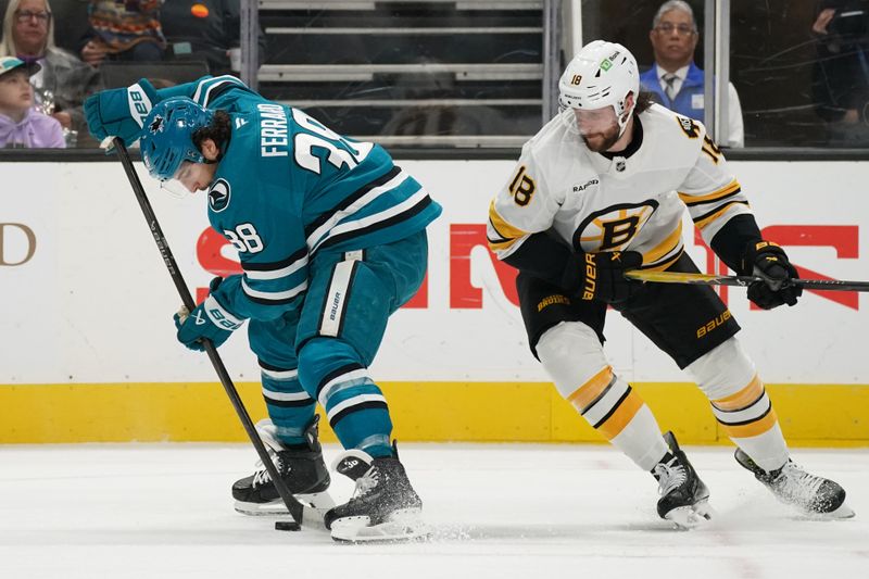 Nov 23, 2025; San Jose, California, USA;  San Jose Sharks defenseman Mario Ferraro (38) controls the puck against Boston Bruins center Pavel Zacha (18) in the first period at SAP Center in San Jose. Mandatory Credit: David Gonzales-Imagn Images