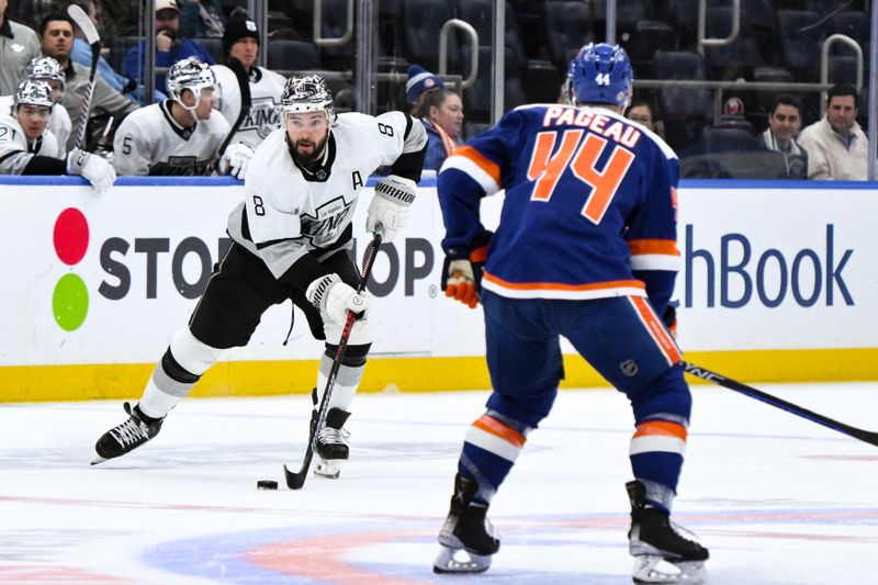 Dec 9, 2023; Elmont, New York, USA; Los Angeles Kings defenseman Drew Doughty (8) skates with the puck while being defended by New York Islanders center Jean-Gabriel Pageau (44) during the first period at UBS Arena. Mandatory Credit: John Jones-USA TODAY Sports